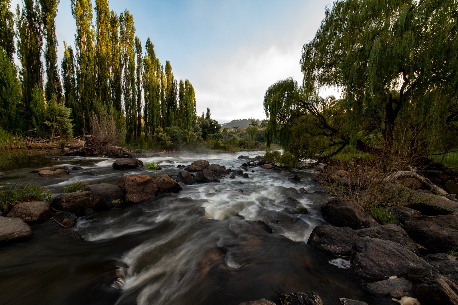 A beautiful shot of the landscape with a long exposure view of a river during sunset in Cooma, NSW, Australia